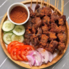 Spicy Nigerian beef suya served with onions and pepper