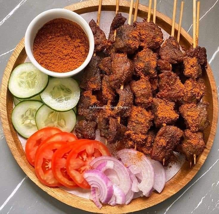 Spicy Nigerian beef suya served with onions and pepper
